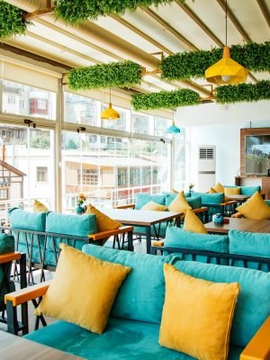 cafe-terrace-with-turquoise-sofas-yellow-pillows
